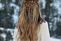 a Viking-inspired half updo with a large braided halo, with braids down and waves down is a chic idea for a boho bride