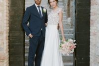 a beautiful A-line wedding dress with a floral applique bodice with cap sleeves and a plain skirt