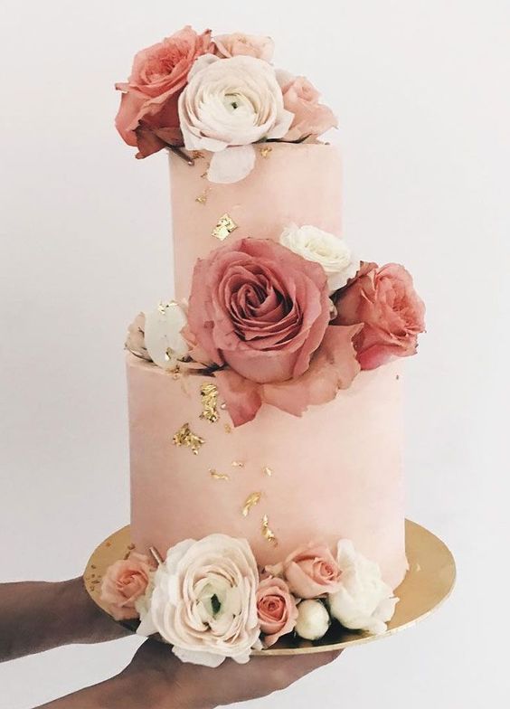 a blush buttercream wedding cake with gold foil, with white, pink and mauve roses is a fantastic idea for a glam wedding