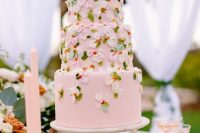 a bright and cool pink wedding cake with sugar blooms in pink and white and sugar leaves is a lovely solution for a garden wedding