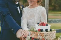 a cheese tower topped with herbs, blackberries and raspberries is a fantastic idea for a vineyard wedding with a boho feel