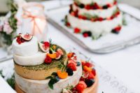a cheese wheel tower topped with fresh fruit and berries plus herbs looks spectacular and is ideal for a vineyard wedding