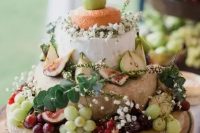 a cute cheese tower with baby’s breath, eucalyptus, grapes and pears is a great idea for a relaxed summer wedding