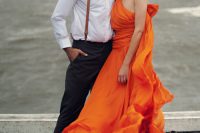 a gorgeous one shoulder orange wedding dress with a draped bodice and a plain skirt, nude shoes and a bold lip for a beach or coastal bride