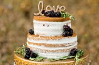 a naked wedding cake with greenery and blackberries, gold calligraphy is a lovely idea for a fall wedding, whether it’s a vineyard one or not