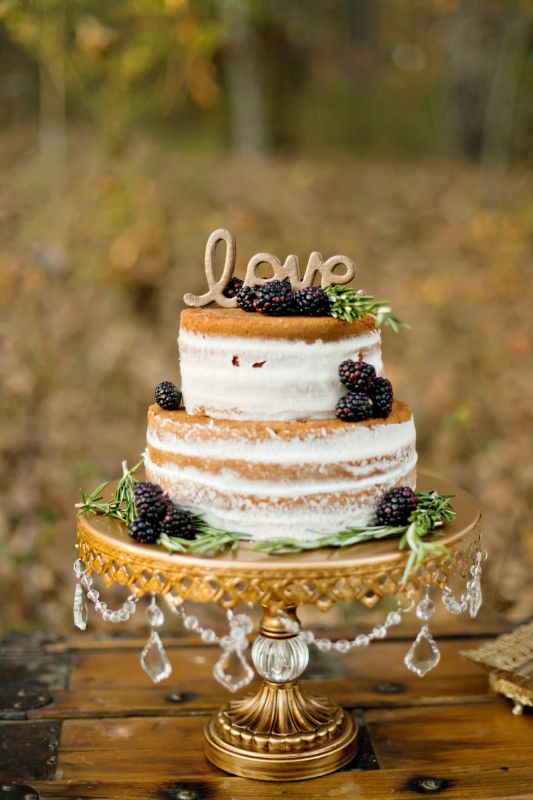 a naked wedding cake with greenery and blackberries, gold calligraphy is a lovely idea for a fall wedding, whether it's a vineyard one or not