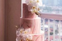 a pink marble wedding cake decorated with white orchids and gold leaves si a very glam and refined idea to rock