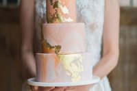 a pink marble wedding cake with gold leaf is a pretty glam idea for a romantic wedding done in pastels