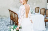 a romantic A-line wedding dress with a lace bodice, long sleeves, a cutout back and a plain skirt