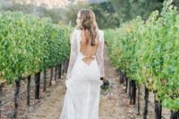 a romantic lace A-line wedding dress with long sleeves and a fully cutout back plus a train