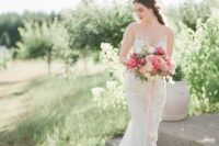 a romantic lace sheath wedding dress with an illusion strapless neckline and a train for a chic look