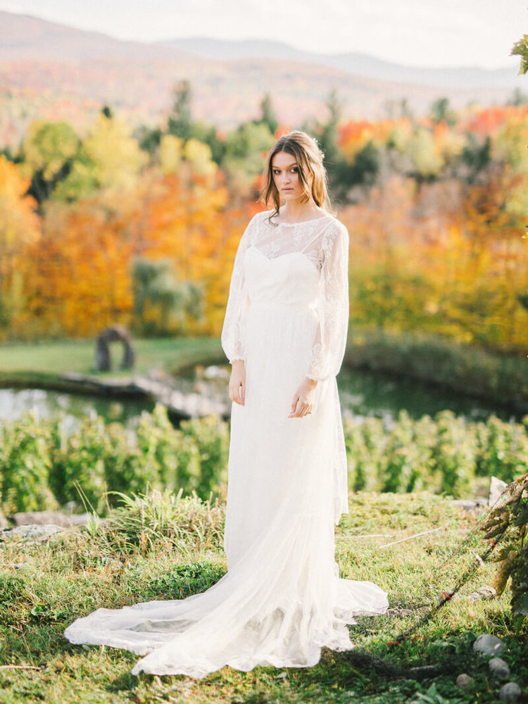A romantic wedding dress with a lace overdress with long sleeves and a train with a vintage feel