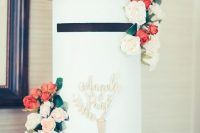 a round box with neutral and red blooms, greenery and gold calligraphy is a chic and stylish idea for your wedding