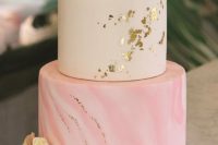 a stylish modern wedding cake with a white and a pink marble tier, with gold foil, white and pink roses and greenery is a chic idea