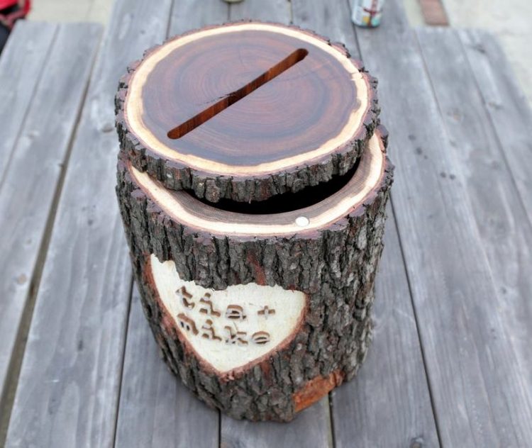 a super creative rustic wedding card box of a wooden log, with cut out names and a glossy lid on top is a cool idea