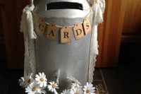 a vintage metal churn with a cavity, with lace ribbons and a banner is a cool idea for a rustic wedding