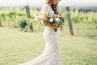 a white lace sheath wedding dress with a square neckline, short sleeves and a long train looks spectacular