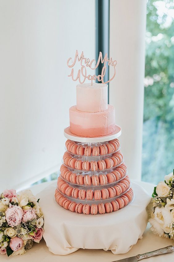 an ombre pink to coral wedding cake, a pink calligraphy topper, coral macarons for a fun and cool summer wedding