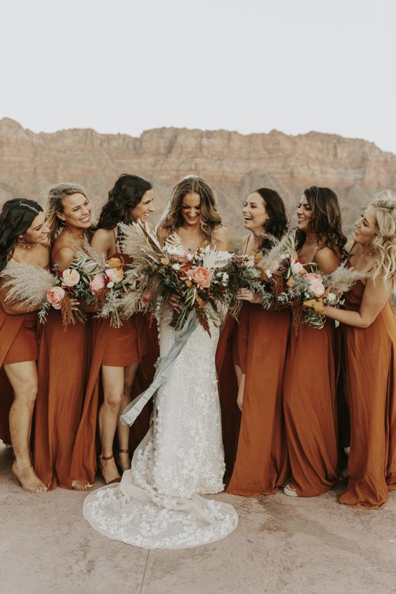 rust-colored high low maxi bridesmaid dresses and boho bouquets for an adorable orange beach wedding