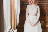 a beautiful vintage-inspired A-line wedding dress with a sheer bodice, a tiered neckline, long sleeves and a skirt wiht some lace