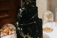 a stylish astronomy-inspired black wedding cake