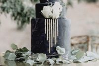 a black marble effect wedding cake with gold stripes, white roses and a textural edge is a refined and chic solution for a modern wedding