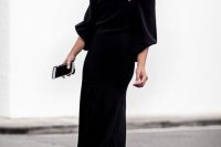 a black off the shoulder midi dress with wide sleeves and black heeled sandals is an ultimate solution for a Halloween bride-to-be