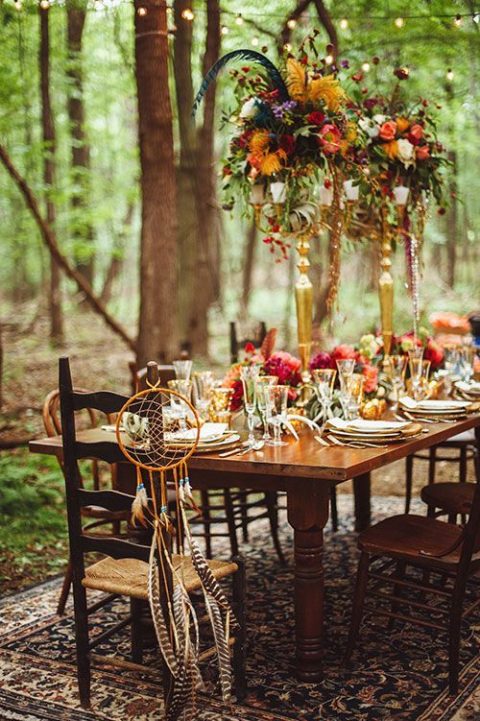 a boho woodland table setting with jewel-tone blooms and gilded touches for a lux feel