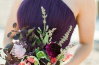 a bold wedding bouquet with plum-colored, lilac blooms, greenery and bold leaves for an elegant fall wedding
