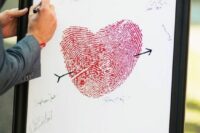a catchy wedding guest book composed of a fingerprint heart and names is a cool idea for a wedding