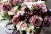a catchyw edding bouquet with mauve, plum-colored, blush and white blooms and leaves is a lovely solution for a fall bride