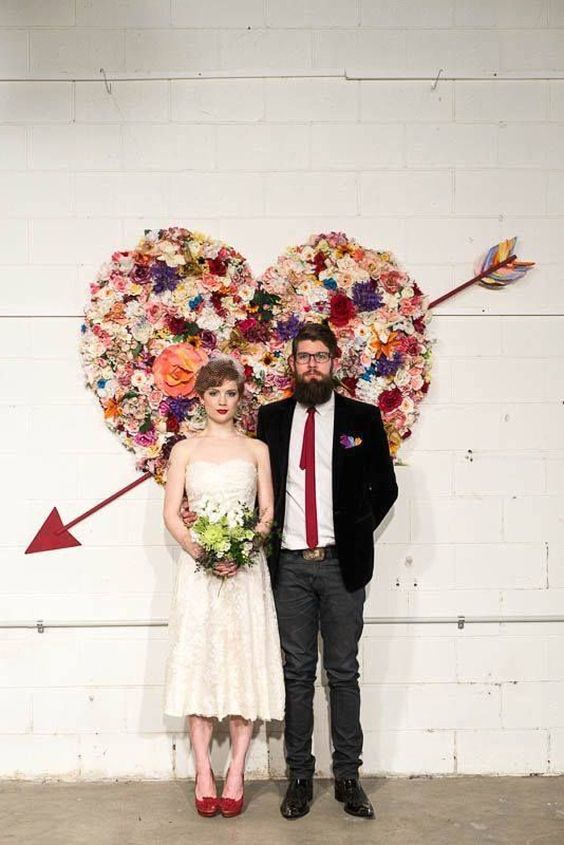 a colorful flower heart wedding backdrop is a bright and cool decor idea for a wedding, not only a Valentine's one