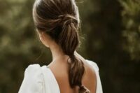 a cool low bubble ponytail wiht twists and a volume on top is a catchy idea for a classic bridal look