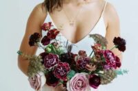 a cool mauve, deep purple and plum-colored wedding bouquet with greenery is a catchy and bold idea