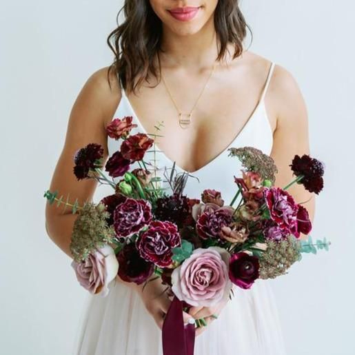 a cool mauve, deep purple and plum-colored wedding bouquet with greenery is a catchy and bold idea