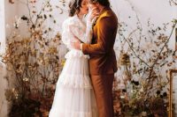 a delicate boho wedding backdrop of dried leaves on branches is a fantastic idea for a fall wedding and it looks gorgeous