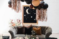 a gorgeous Halloween bridal shower lounge with dark balloons, lush florals and refined furniture is idea for your party