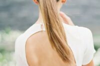 a gorgeous sleek twisted ponytail is the best option for a minimalist bride
