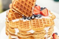 a heart-shaped waffle wedding cake topped with blueberries and strawberries is a tasty and cool dessert
