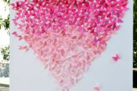 a lovely wedding backdrop with an ombre paper butterfly heart is a gorgeous idea for a ceremony or a photo booth