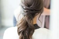 a low ponytail with twists and waves for a modern beach bride, it’s a stylish solution for many weddings, and it can be worn with long or medium-length hair