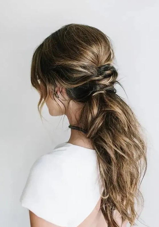 a messy low ponytail with a twisted part and some locks down is idea for hair with lowlights, a comfy modern hairstyle