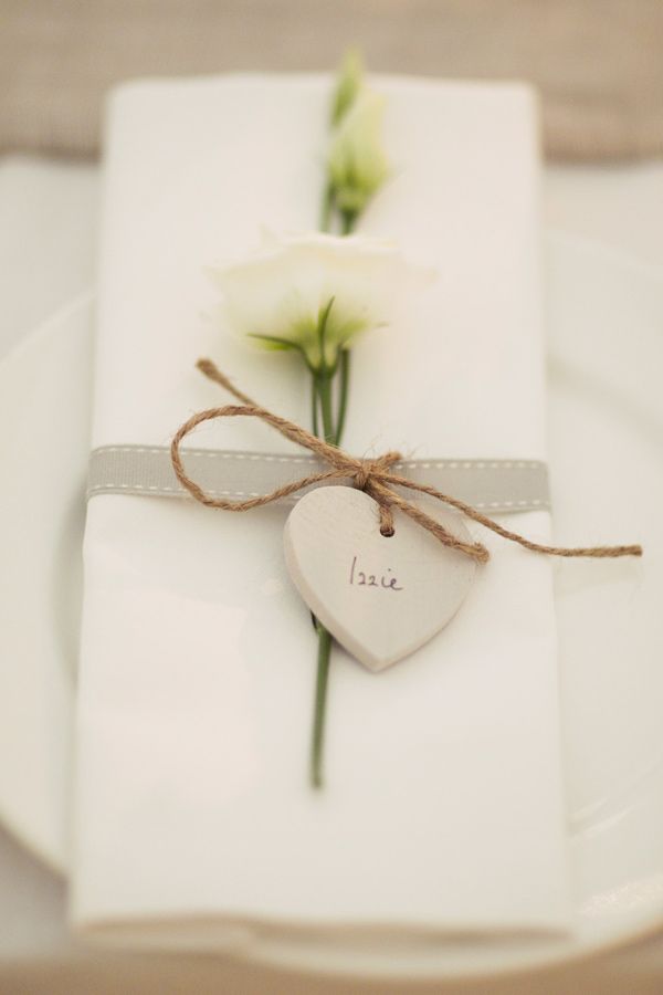 a napkin accented with white blooms and a clay wedding card is a lovely modern wedding idea, you can DIY it