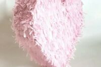 a pink fringe heart-shaped pinata is a very pretty and lovely idea with a touch of romance is a cool wedding guest book