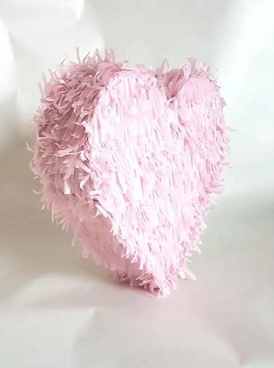 a pink fringe heart shaped pinata is a very pretty and lovely idea with a touch of romance is a cool wedding guest book