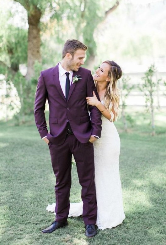 A plum colored groom suit with a thin black tie and black shoes is a gerat alternative to traditional black or grey