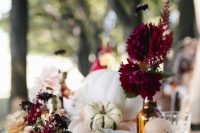 a pretty Thanksgiving table with natural pumpkins, bold blooms and color block touches is a lovely idea for the fall