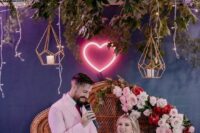 a pretty neon heart sign can mark your wedding sweetheart table is a lovely idea for a modern wedding