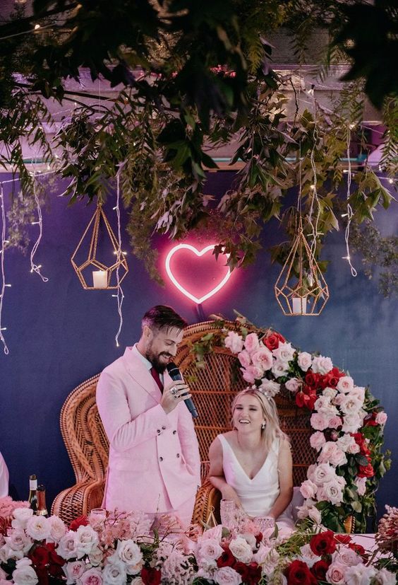 a pretty neon heart sign can mark your wedding sweetheart table is a lovely idea for a modern wedding