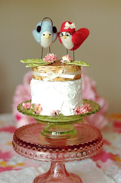 a quirky wedding cake with bark tiers, blooms and colorful felt bird cake toppers that are personalized according to the couple's looks and tastes